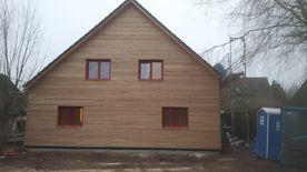 Hinterlüftete Vorhangfassade mit UV-Beständiger Fassadenbahn, auf die Konstruktion kam eine Rombusschalung aus sibirischer Lärche.